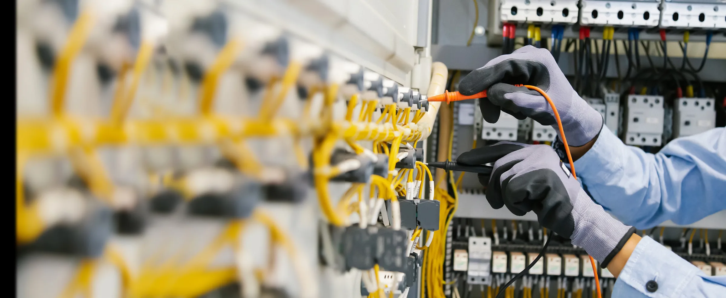 Electrician wiring a control panel