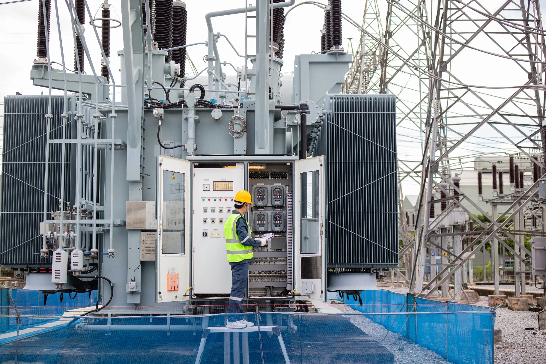 Engineer working on a substation transformer